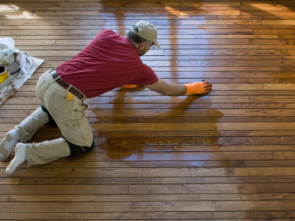 a spring floor refinisher hard at work updating a wood floor.